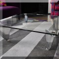 F04. Custom made glass and aluminum flipper coffee table. 11"h x 35"w x 35"d 